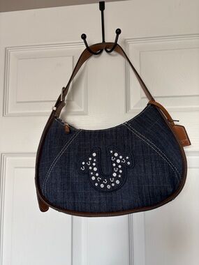 True Religion Dark Denim Shoulder Bag with Brown Trim and Rhinestone Logo